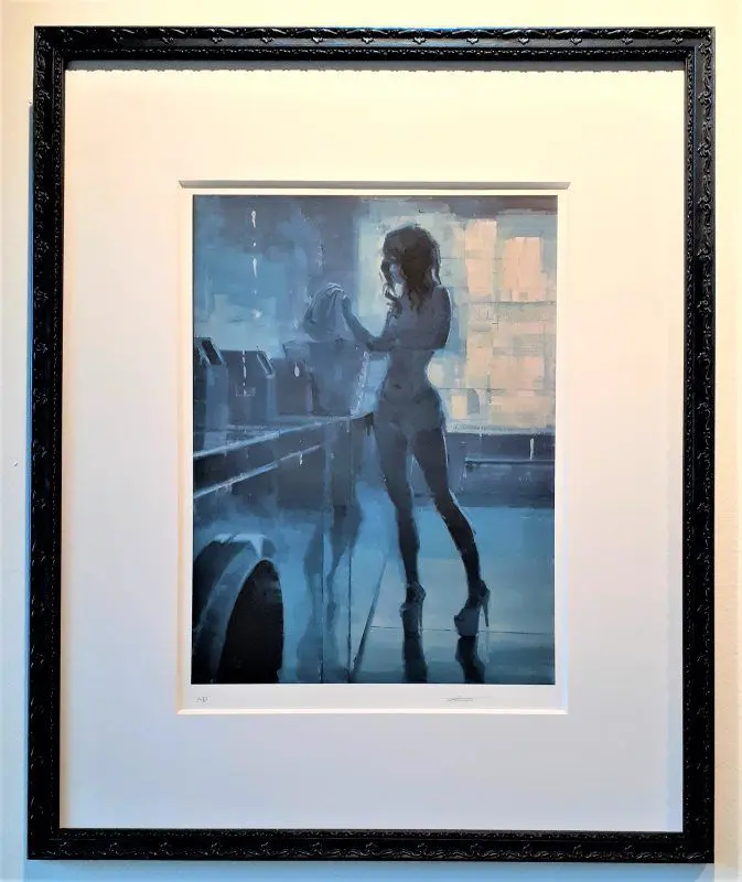 Framed painting of a silhouette by laundry.