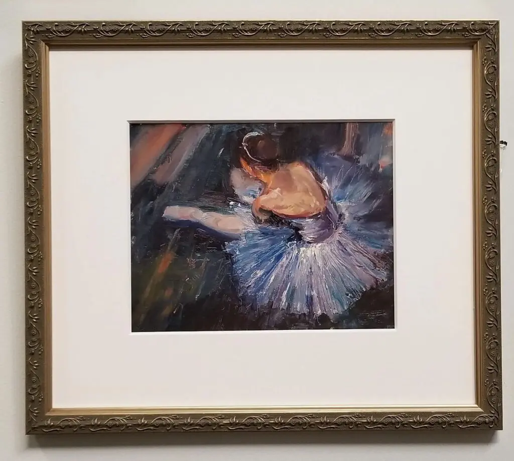 Framed painting of a seated ballerina.