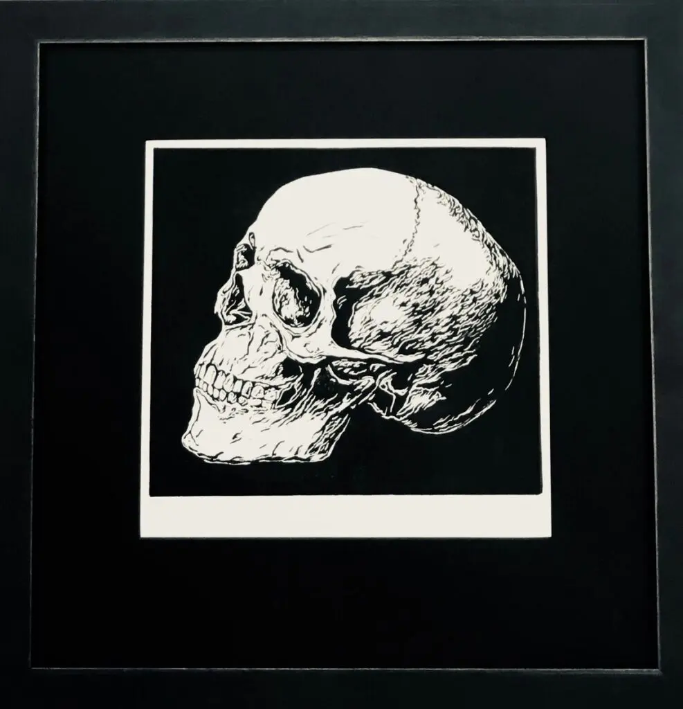 Framed black and white skull illustration.